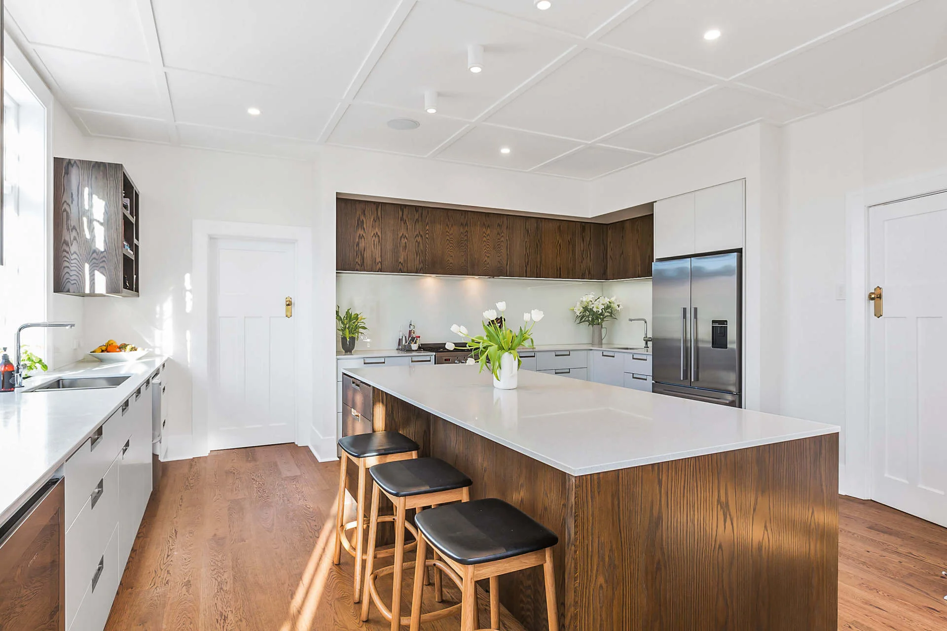 Completed kitchen renovation with island seating and timber cabinets